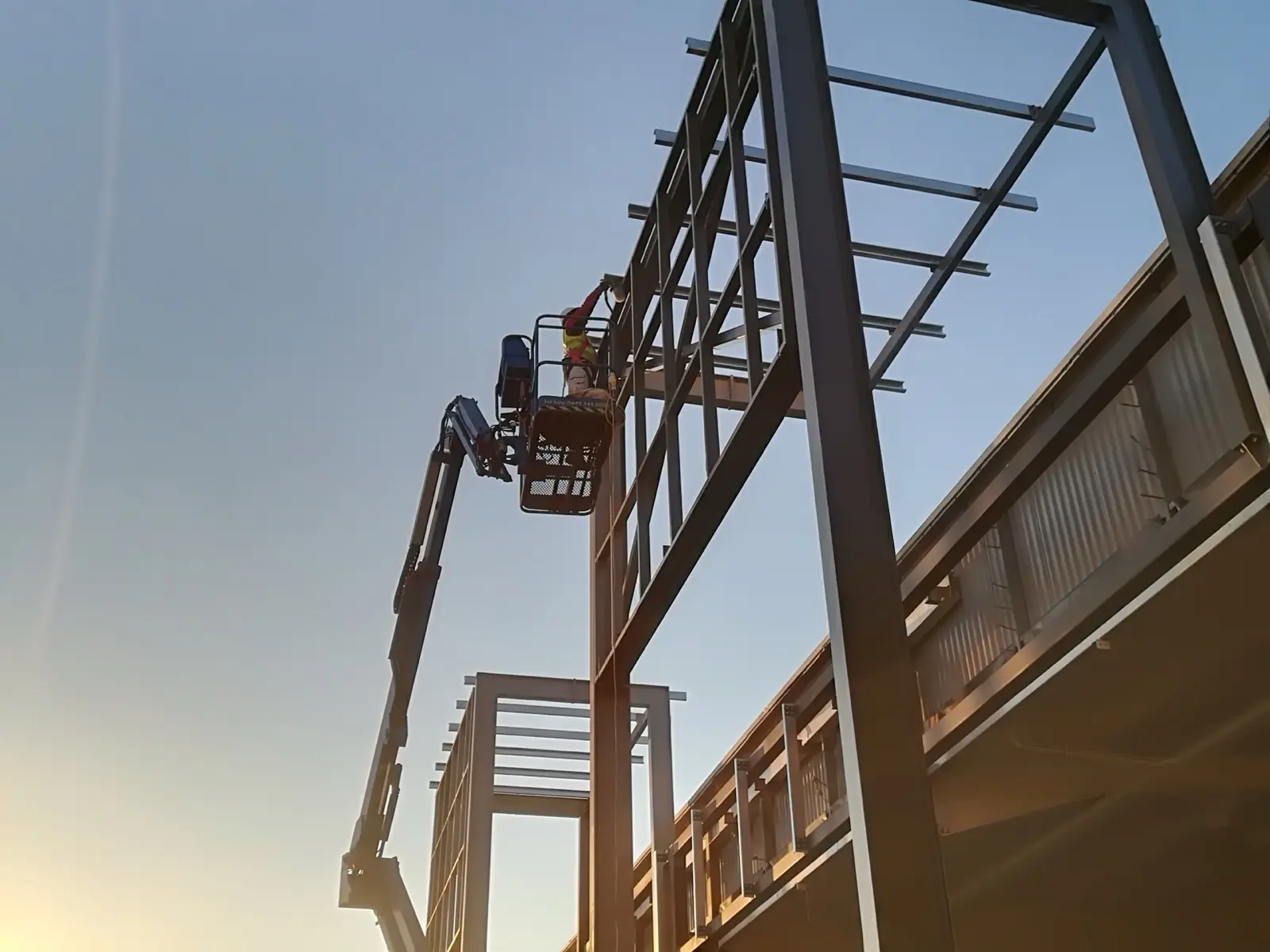 Structural steelwork on a commercial site at dusk - McGregor Builders